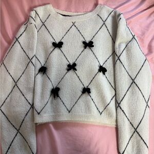 Elegant White and Black Sweater with Bow Accents